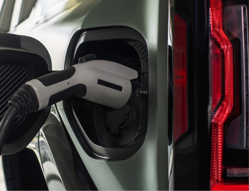 Close up of charging port with charger plugged in on a GMC Hummer EV SUV - Johnson GMC in BUDD LAKE NJ