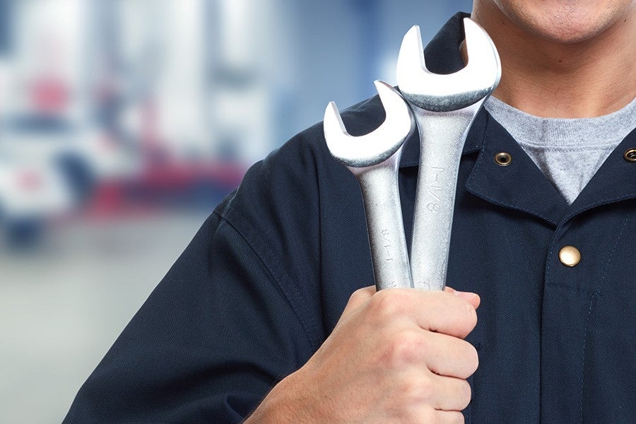 Person holding wrenches